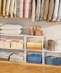 3 Pack Expandable Metal Closet Organizer Shelves with folded clothes, pillows, and handbags for neat home storage.