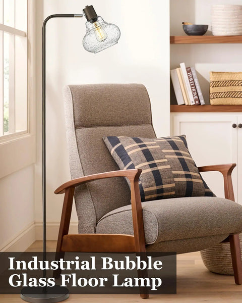 Farmhouse Bubble Glass Floor Lamp With Adjustable Tall Pole beside armchair, oil rubbed bronze finish, 6W Edison bulb, hand blown glass shade.