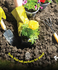 Gardener using 10 Piece Garden Tools Set with heavy duty hand tools and ergonomic handles planting flowers, visible trowel and fork.