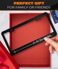 Person holding Aluminum License Plate Frame With Matte Black Finish Dope Cartoon Inspired Design 12.2x6.3 Inches Standard US Canada Fit Screws And Clips Included Car Truck SUV Accessories For A Sleek Ride in gift box