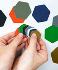 Hands holding Hex Peel And Stick Repair Patches Kit with two 2.5 inch and two 1.5 inch patches in clear and black, multiple colors shown.