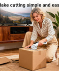 Woman using Cordless Electric Scissors Heavy Duty Fabric Cutter to cut cardboard box on living room floor.