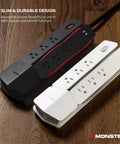 Vertex Six Outlet Power Center Surge Protector With Four Foot Detachable Magnetic Mount And USB Hub Two USB A And One USB C For Computers TVs Audio Gear White, shown alongside a black model, highlighting slim design on wood surface.