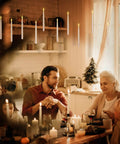 Floating LED Taper Candle Set 10.8 Inches With Remote Wand illuminating warm light over a family dinner in a cozy room.