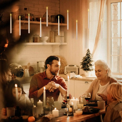 Floating LED Taper Candle Set 10.8 Inches With Remote Wand illuminating warm light over a family dinner in a cozy room.