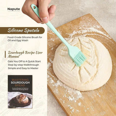 Hand brushing dough on cutting board with silicone spatula from Complete Sourdough Starter Kit With 9-Inch Round And 10-Inch Oval Banneton Proofing Baskets Plus 7 Essential Tools For Home Bakers Lame With 5 Blade Guard Bench Scraper Whisk Silicone Spatula Pastry Brush Bread Sling And Bag.