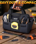 Heavy Duty Tool Bag with multi pocket for pros, built from 600D Oxford fabric, on workbench with tools, 12 inch base, black