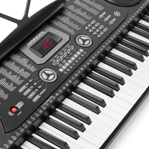 Close-up of a 61 Key Portable Keyboard Piano Kit With Stand, Built-In Speakers, Microphone, And Learning System For Beginners, showing control panel.