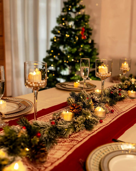 Festive dining table with 12 Pack Flameless Tea Lights With Timer Auto On For 6 Hours, Off 18 Hours Everyday, elegant holiday decor.