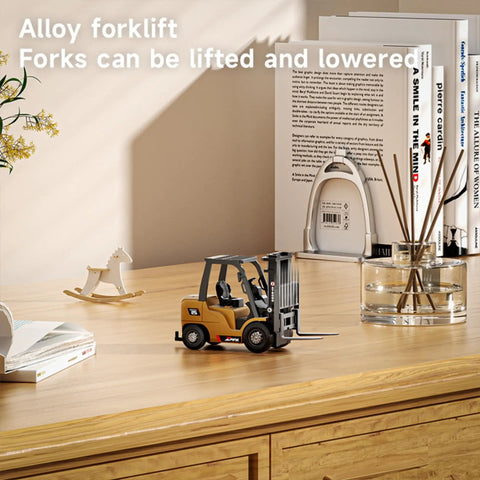 One Sixty Fourth Scale Alloy RC Forklift Toy With Lights And Sounds on a wooden desk with decor items in the background