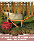 Wheelbarrow with red manure fork near fence, great for cleaning up, featuring Six Piece Set Of Manure Fork Replacement Heads Red With 18 Tines Screws And Nuts For 1 Inch Handles Ideal For Horse Manure Rake To Gather Grass And Hay.