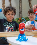 Kids wearing blue safety glasses playing with colorful toy outdoors, focus on Kids Blue Safety Glasses Lightweight Protective Eyewear.