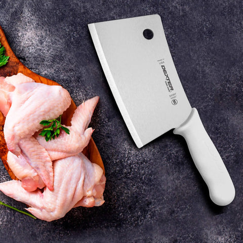 7 Inch Meat Cleaver With High Carbon Steel Blade Textured Slip Resistant Handle NSF Certified Heavy Duty Butchering Knife For BBQ And Kitchen Prep Made In USA next to raw chicken pieces