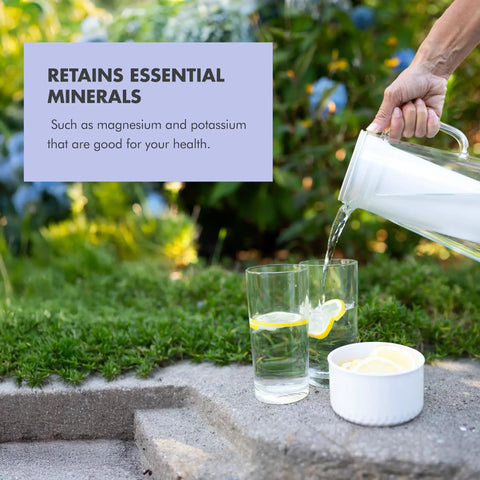 Image of Water Filter Pitcher 10-Cup BPA Free Wisteria for Everyday Protection pouring water into glass outdoors.