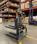 Heavy Duty Electric Pallet Stacker Forklift With Remote Control 661 Lbs Capacity adjustable forks in warehouse setting.