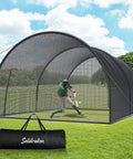 Backdrop of a backyard baseball and softball batting cage with enclosed net and pitching hole, sturdy frame, and carry bag visible.