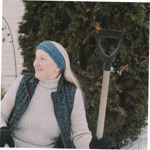 Person holding Garden Spade Handle Replacement For Shovel near shrubs, showcasing easy grip and durability.