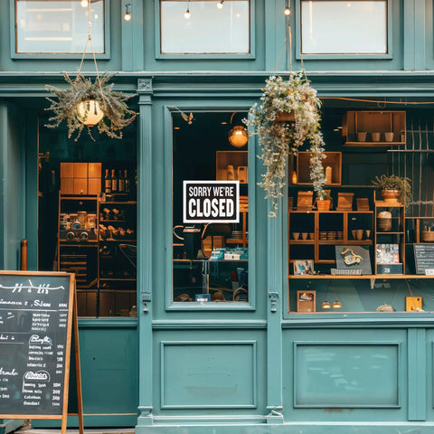 Open And Closed Sign 12x16 Inch Double Sided Vinyl Sign For Storefronts Offices Restaurants Bars Shops Waterproof Indoor Signage With Bold Lettering No Sweat For Window Doors Front Desk And Lobbies 1 Pack displayed on a store window with a closed sign.