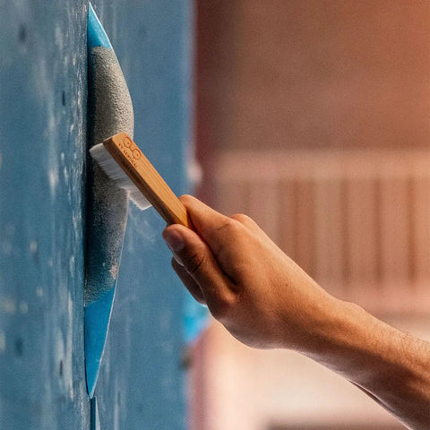 Hand using Best Ever Climbing Brush For Chalk And Bouldering Vegan Chalk Bag Friendly Rock Climbing Brush Ultra Efficient Chalk Remover