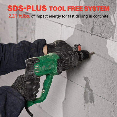 Side view of green Deshuo 1-inch SDS-Plus rotary hammer drill, corded, drilling into concrete with gloves.