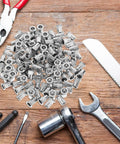 Top Quality Stainless Steel Flat Head Knurled Rivet Nuts 30 Pcs for Bold DIY Builds on a wooden table with tools.