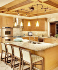 Modern kitchen with pendant lights over island, showcasing elegant cabinetry and stainless steel appliances in bright, spacious setting.