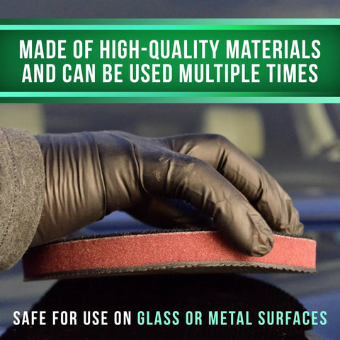 Hand using Reusable Medium Grade Nano Clay Pad For Auto Detailing 6 Inch Orbital Synthetic Clay Bar Pad on glass surface