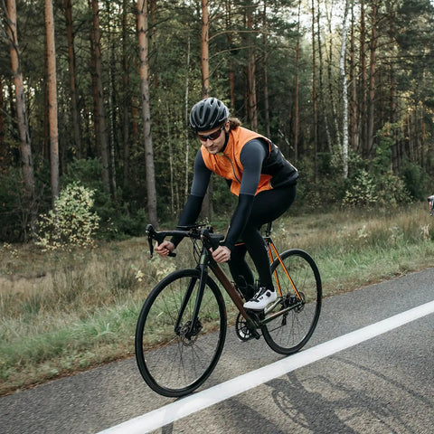 Cyclist on a road bike with Two Pack 700C Road Bike Tires And Heavy Duty Tubes With Presta Valve For 700X25C To 700X26C.