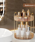 Kick Back And Organize Your Vanity Game With This Smooth Spin 360 Rotating Makeup Organizer Featuring Two Tier High Capacity Storage For Cosmetics Skincare And Perfume In Classic Amber Gold placed in a bathroom.