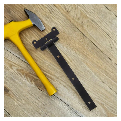 Heavy Duty Self Closing Reversible T Shaped Door Hinge in Black Finish next to yellow hammer on wooden surface