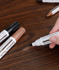 No Sweat Scratch Fix Kit 18 Color Wood Markers Plus Fillers For Furniture Laminate Hardwood Floors Cabinets Doors Quick Stain Match being used on scratch.