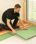 Man installing Premium Wood Fiber Flooring Underlayment 6mm Covers 180 Sq Ft Solid Acoustic Insulation