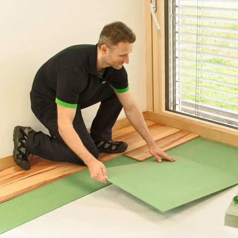 Man installing Premium Wood Fiber Flooring Underlayment 6mm Covers 180 Sq Ft Solid Acoustic Insulation