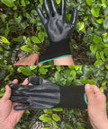 Person wearing nitrile coated work gloves with superior oil resistance and strong grip for gardening in green foliage.