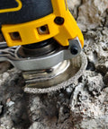 Diamond oscillating tool blade attached to yellow multi-tool used for grout removal in concrete