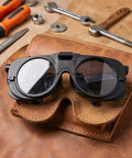 Premium Heavy Duty Industrial Double Lens Welding Goggles Featuring Top Shelf Anti Glare Optics on leather tool holder.