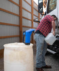 Heavy Duty Hand Operated Diesel Exhaust Fluid Transfer Pump For 55 Gallon Drums on a white barrel with a user filling a container.
