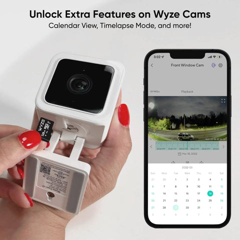 Expandable 32GB MicroSDHC Card Class 10 UHS-I U1 being inserted into a Wyze Cam with smartphone app interface displayed.