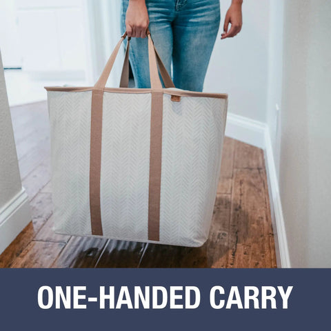 Woman carrying Grab And Go Collapsible Laundry Caddy Tote With Handles, XXL 64L Pop Up Laundry Basket in Luxe Cream Herringbone