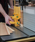 Person using GRR RIPPER GR 200 Advanced Adjustable Table Saw Pushblock on wood piece for precise cuts in workshop