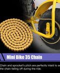 Gold 140-link mini bike chain coiled beside a yellow bike frame near the rear wheel sprocket.
