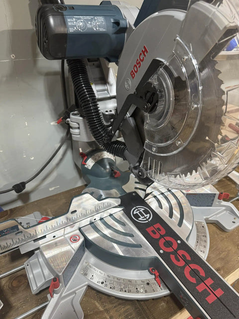 Custom 3D Printed Dust Collection Attachment for 12 Inch Glide Miter Saw GCM12SD installed, showing black adapter and hose hookup.
