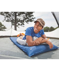 Person relaxing on Self-Inflating Sleeping Pad With Pillow For Camping, Lightweight Portable Camp Pad With Extra Support inside tent
