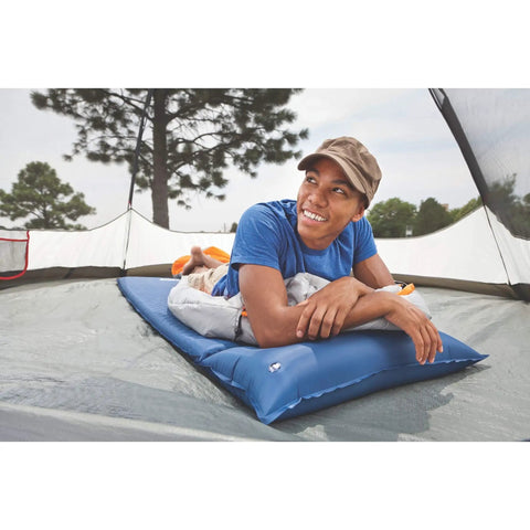 Person relaxing on Self-Inflating Sleeping Pad With Pillow For Camping, Lightweight Portable Camp Pad With Extra Support inside tent