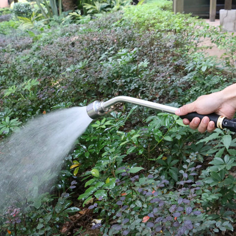 18 Inch Soft Rain Watering Wand With Shut Off Valve in use, watering garden greenery with gentle spray.