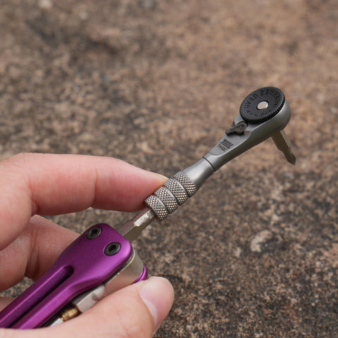 Close-up of Pocket Size Micro Ratchet Wrench with knurled grip, held in hand for electronics watch phone and device repair
