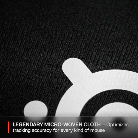 Close-up of the micro-woven cloth surface of the QcK Large Gaming Mousepad With Non Slip Silicone Rubber Base For Peak Tracking And Rock Solid Stability Pro Grade Surface Optimized For Gaming Sensors 490 mm By 420 mm Perfect For FPS MOBAs RTS MMO Play, showcasing its texture and logo.