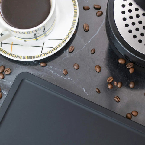 Ultra Thick Espresso Tamping Mat For Large 5x12 Inch Coffee Bar Station Silicone Tamper Pad with coffee cup and beans on countertop