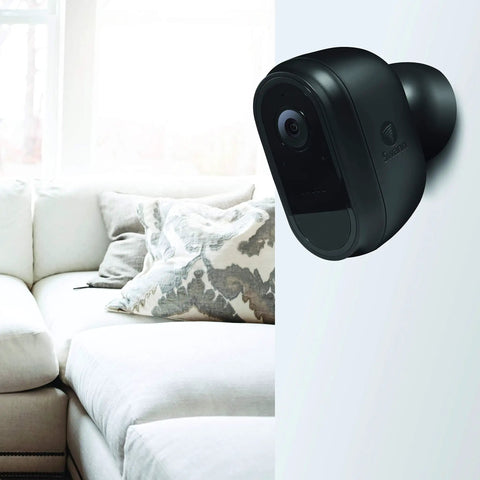 Wire Free 1080p Security Camera For Indoor And Outdoor Use, battery powered on wall next to white sofa