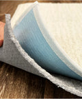 Close-up of Non Slip Rug Pad Runner Two Point Five By Nine Feet Thick Quarter Inch Felt And Rubber Duo Lock Grip being lifted